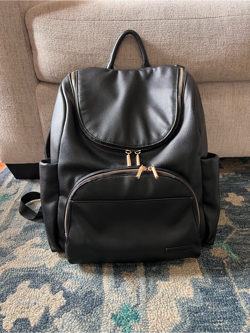 Skip Hop Evermore 6-in-1 Black Textured Faux Leather Backpack with Gold Hardware